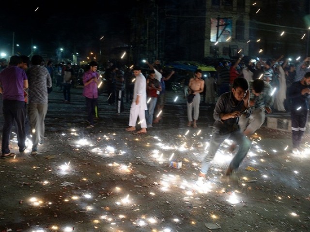 Kashmirisplay with fireworks as they applaud after Pakistan won a Champions trophy, in Srinagar. PHOTO: AFP 