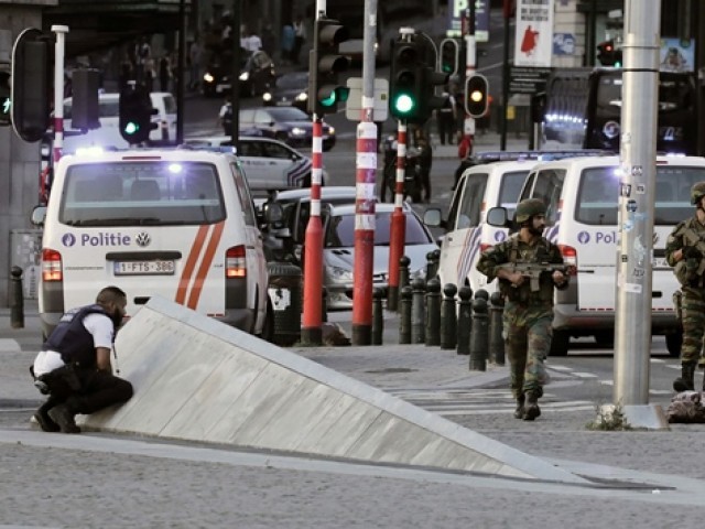 Police officials and soldiers mount warning in a cordoned off area outward Gare Centrale in Brussels. PHOTO: AFP