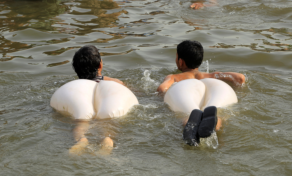 Boys swim in a stream during a heatwave in Islamabad, Pakistan. PHOTO: REUTERS