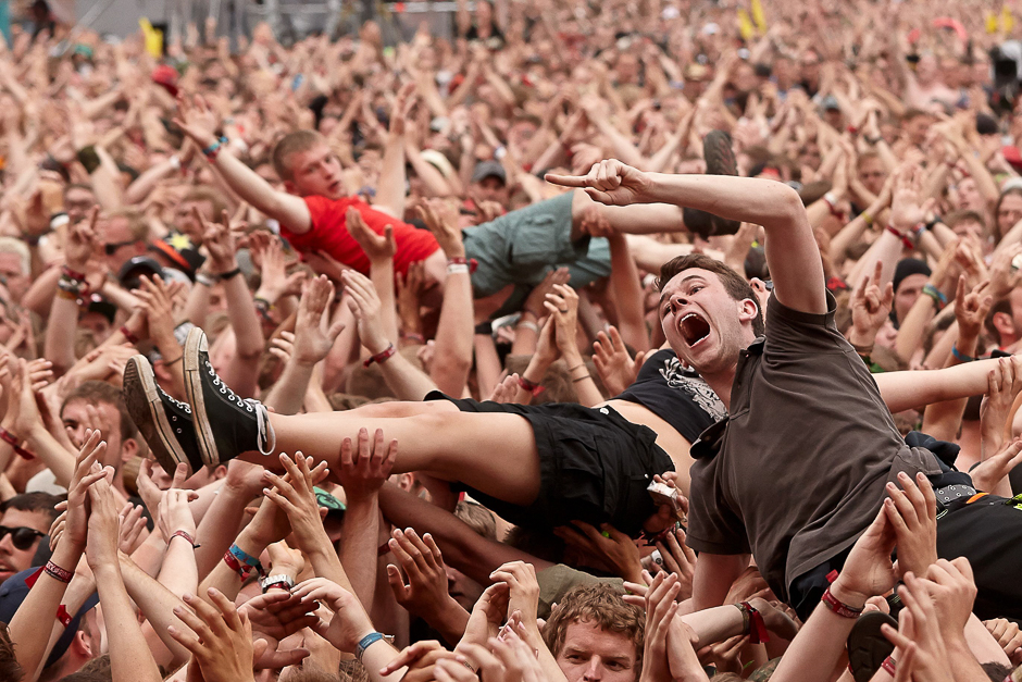 Crowdsurfers are pictured during a performance of 