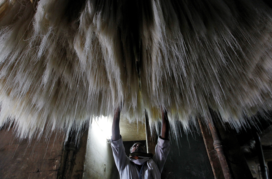 A man arranges strands of vermicelli, a specialty eaten during the Muslim fasting month of Ramadan, to dry at a factory in Allahabad, India. PHOTO: REUTERS