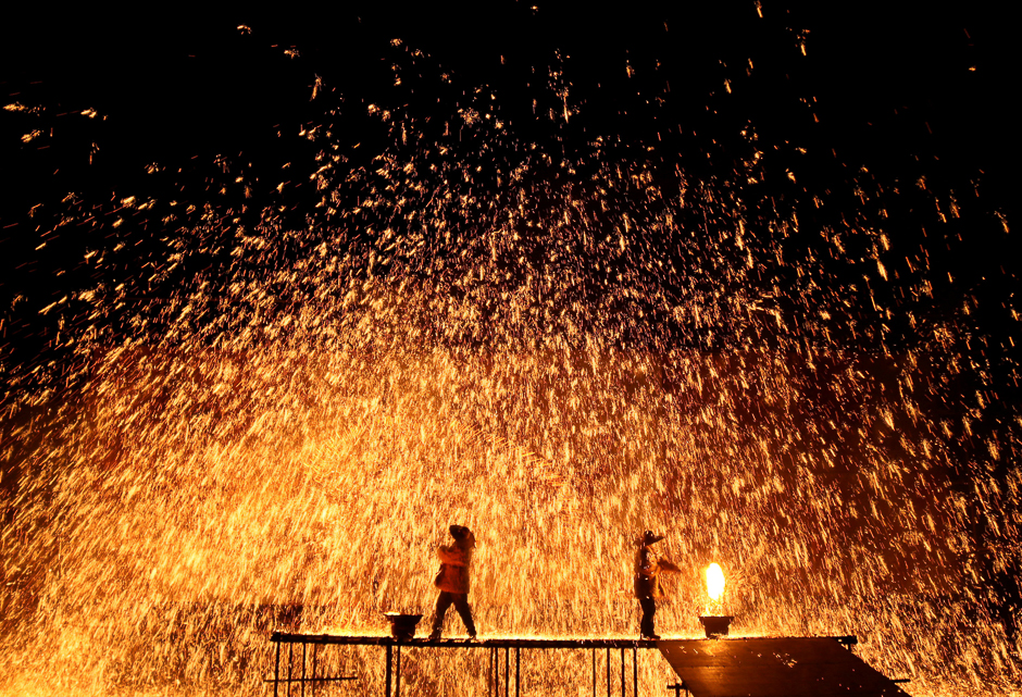 Performers throw molten iron against a wall to create sparks during a traditional performance ahead of the Dragon Boat festival in Zhangjiakou, Hebei province, China. PHOTO: REUTERS