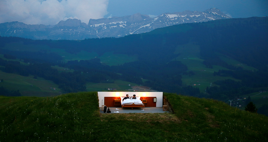 Raphael and Mirjam (R) pose as first guests in the bedroom of the Null-Stern-Hotel (Zero-star-hotel) land art installation by Swiss artists Frank and Patrik Riklin on an alp mount Saentis near Gonten, Switzerland. PHOTO: REUTERS