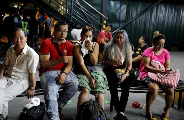 Tourists are pictured after being evacuated from a Resorts World building in Pasay City, Metro Manila, Philippines June 2, 2017. PHOTO: REUTERS