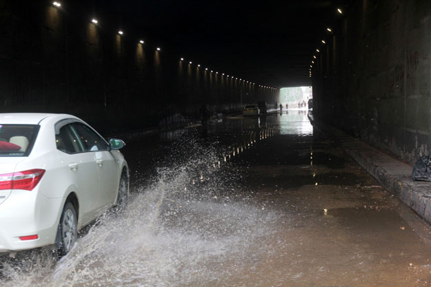 Many cars were stuck in the water that accumulated in the Liaquatabad Underpass on Friday morning. PHOTO: ATHAR KHAN/EXPRESS