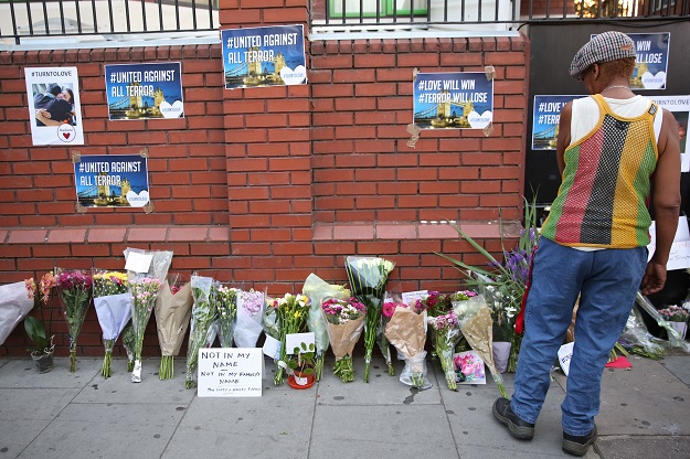 A man looks at floral tributes left close to the scene of a van attack in Finsbury Park, north London. PHOTO: AFP