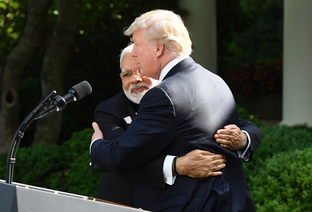 US President Donald Trump (R) and Indian Prime Minister Narendra Modi (L) hug after speaking to the press in the Rose Garden of the White House in Washington, DC. PHOTO: AFP