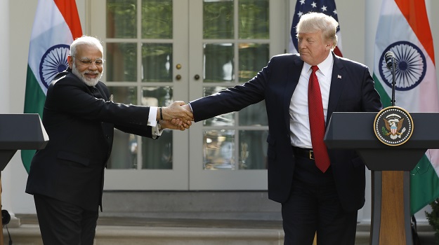 U.S. President Donald Trump (R) greets Indian Prime Minister Narendra Modi during their joint news conference in the Rose Garden of the White House in Washington, US. PHOTO: REUTERS