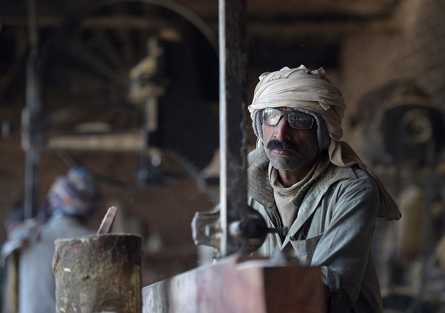 aqsood Ahmed, who sold one of his kidneys, works at a wood workshop in Bhalwal in Sargodha District, in Punjab. PHOTO: AFP