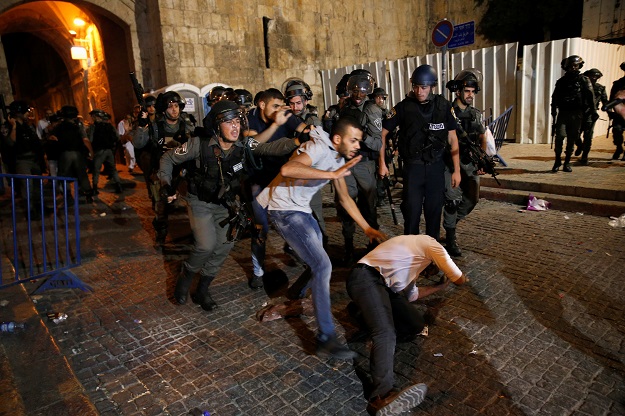 Israeli border police disperse a Palestinian man during scuffles that erupted after Palestinians held evening prayers outside the Lion's Gate of Jerusalem's Old City. PHOTO: REUTERS