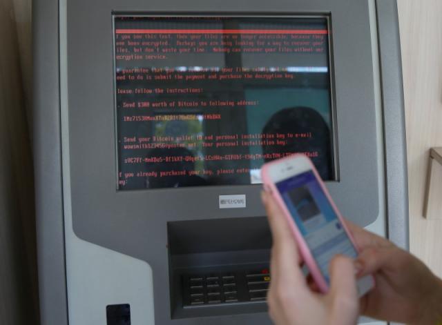 a message demanding money is seen on a monitor of a payment terminal at a branch of ukraine 039 s state owned bank oschadbank photo reuters