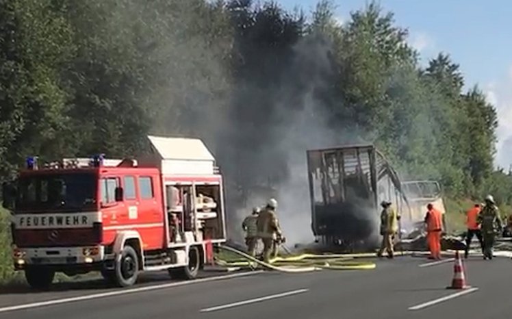 firefighters walk at the site where a coach burst into flames after colliding with a lorry on a motorway near muenchberg germany july 3 2017 photo reuters