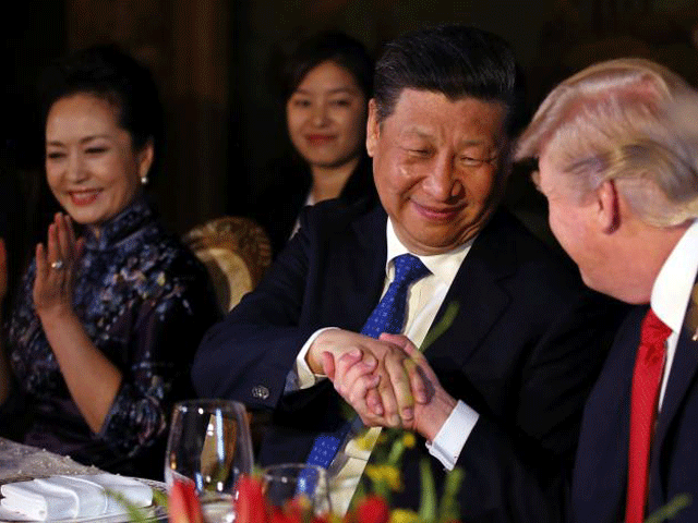 chinese president xi jinping shakes hands with president donald trump as he is accompanied by china 039 s first lady peng liyuan during a dinner at the start of a summit between president trump and president xi at trump 039 s mar a lago estate in west palm beach florida photo reuters