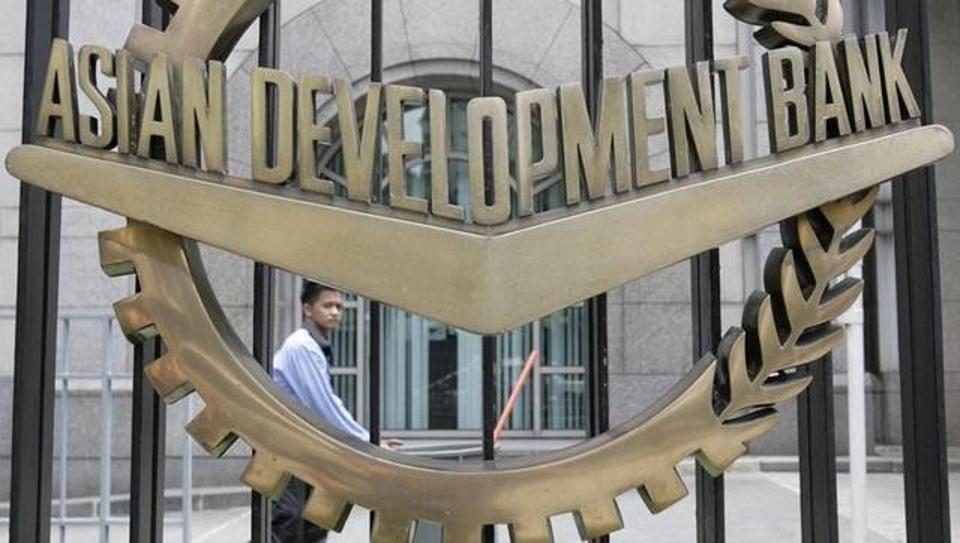 a worker walks past inside the asian development bank adb headquarters in manila photo reuters