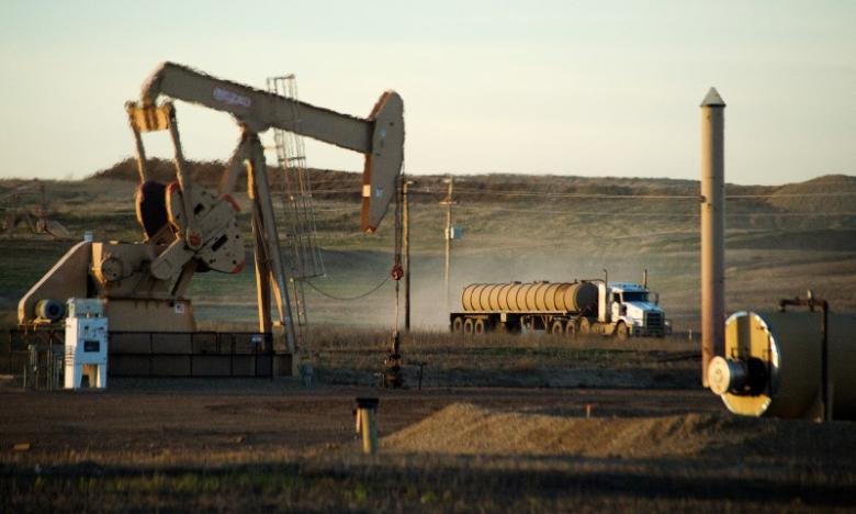 a service truck drives past and oil well photo reuters