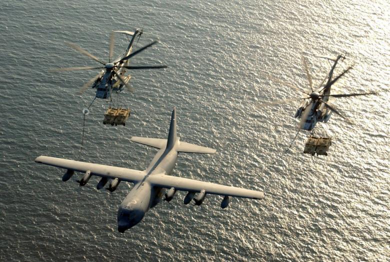 two us marine corps ch 53e super stallion helicopters receive fuel from a kc 130 hercules over the gulf of aden photo reuters