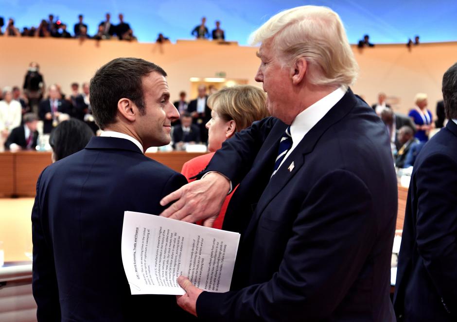 us president donald trump claps the shoulder of french president emmanuel macron at the start of the first working session photo reuters