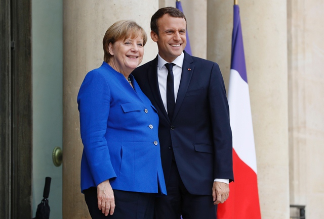 german chancellor angela merkel l poses beside french president emmanuel macron during an annual franco german summit at the elysee palace in paris on july 13 2017 photo afp