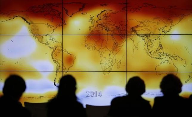 participants looks at a screen projecting a world map with climate anomalies during the world climate change conference 2015 cop21 at le bourget photo reuters