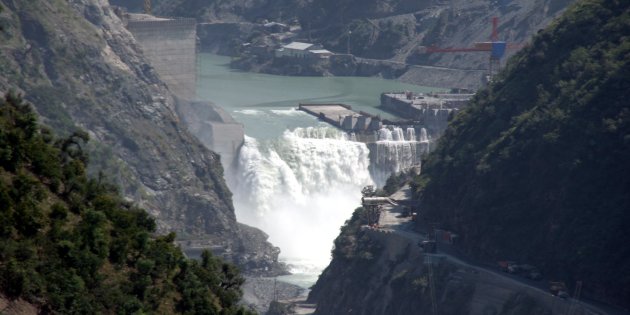 water flows on the banks of chenab river with the baglihar hydroelectric project in the background photo reuters