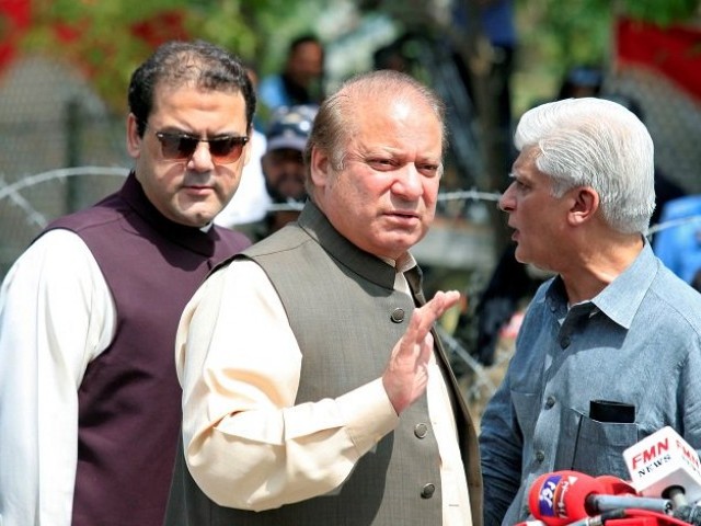 Prime Minister Nawaz Sharif waves as his son, Hussain Nawaz looks on. PHOTO: REUTERS
