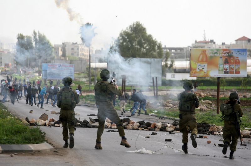 israeli soldiers fire tear gas canisters towards palestinian protestors during clashes near the west bank city of jenin photo afp