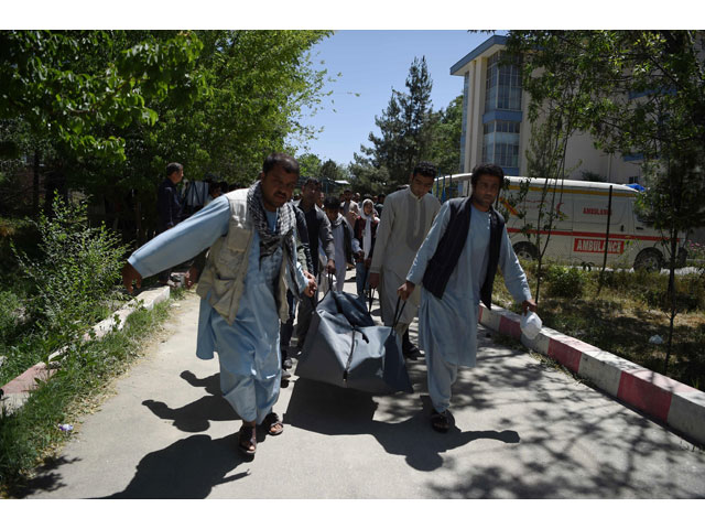 this file photo taken on may 31 2017 shows afghan volunteers carrying the body of a resident killed in a car bomb attack to the wazir akbar khan hospital in kabul photo afp