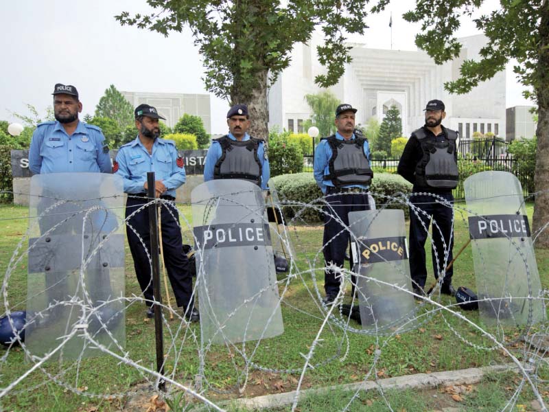 policemen stand guard outside the supreme court building photo reuters