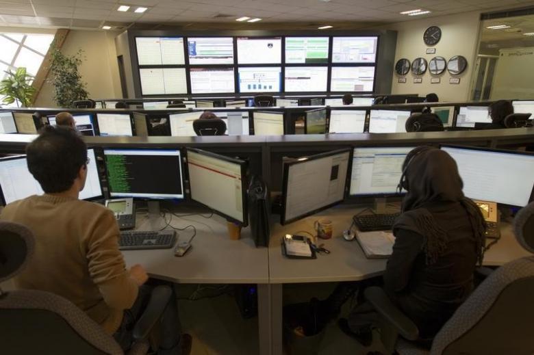 technicians monitor data flow in the control room of an internet service photo reuters