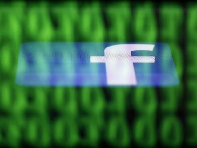 A Facebook logo on an Ipad is reflected among source code on the LCD screen of a computer, in this photo illustration taken in Sarajevo June 18, 2014. PHOTO: REUTERS