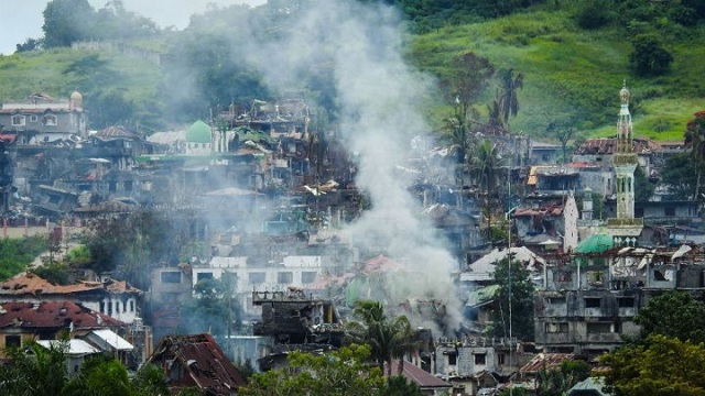 smoke billows from burning houses as fighting between government troops and islamist militants continues in marawi on the southern island of mindanao on july 3 2017 photo afp