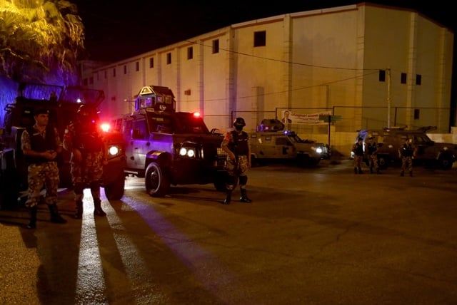 security forces stand guard outside the israeli embassy in the residential rabiyeh neighbourhood of the jordanian capital amman following an 039 incident 039 photo afp