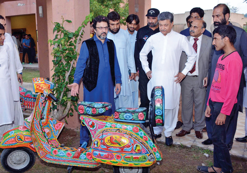 mayor anser aziz looks at a vespa scooter decorated with traditional truck art photo inp