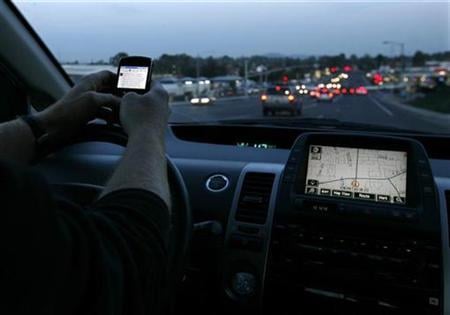 a driver uses his smart phone while in traffic photo reuters