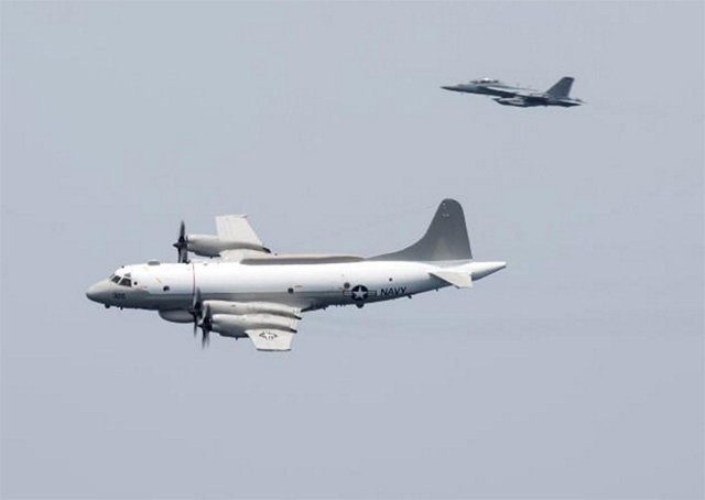 a us navy ep 3e aries signals reconnaissance aircraft escorted by an ea 18g growler electronic warfare aircraft performs a flyby over aircraft carrier uss harry s truman in the arabian gulf april 24 2016 photo reuters file