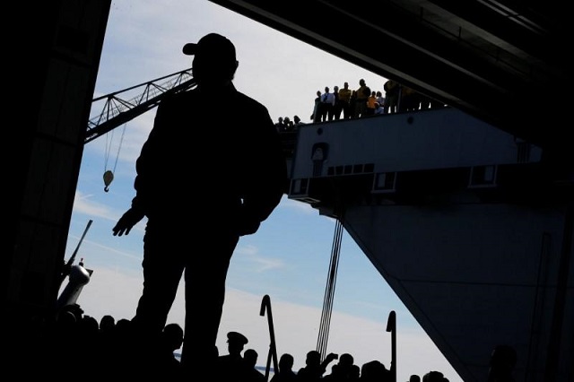 us president donald trump takes the stage in the flight hangar to deliver remarks aboard the pre commissioned us navy aircraft carrier gerald r ford at huntington ingalls newport news shipbuilding facilities in newport news virginia us march 2 2017 photo reuters