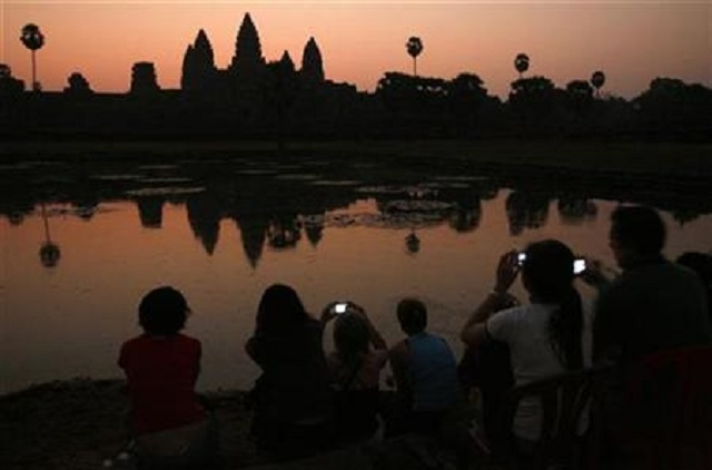 tourists take photos of the sunrise over angkor wat in siem reap photo reuters