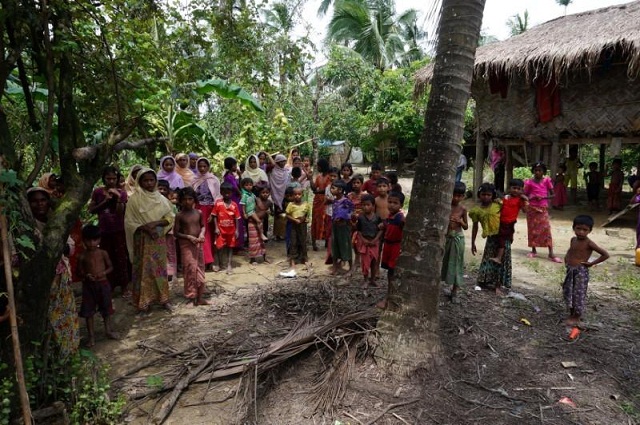 rohingya villagers watch as international media visit maung hna ma village buthidaung township northern rakhine state myanmar july 14 2017 picture taken july 14 2017 photo reuters