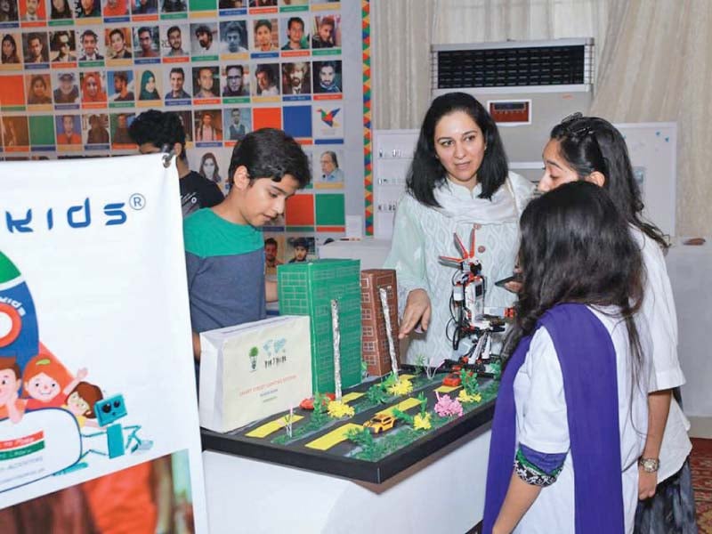 students display their creative project at a stall photo express