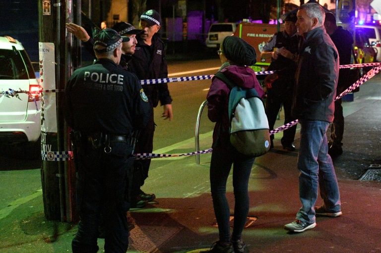 police speak to passersby as they man a check point in the inner sydney suburb of surry hills photo afp