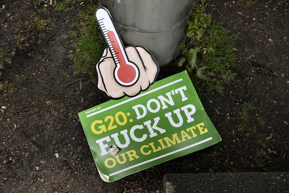An anti G20 placard lies on the ground during a demonstration called by several NGOs ahead of the G20 summit in Hamburg. PHOTO: AFP
