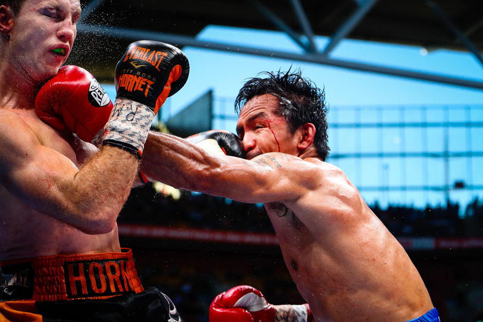 Manny Pacquiao (R) of the Philippines fight Jeff Horn (L) of Australia during the World Boxing Organisation boat at Suncorp Stadium in Brisbane. PHOTO: AFP