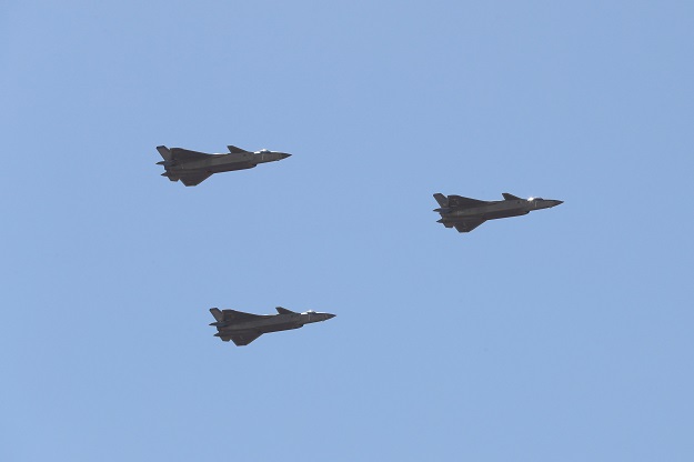 1.Chinese J-20 stealth fighter jets fly past during a military parade at the Zhurihe training base in China's northern Inner Mongolia region. PHOTO: AFP