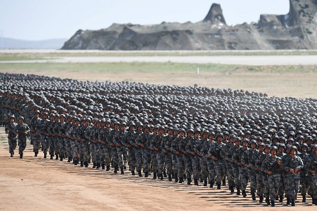 2.Chinese soldiers march in a military parade at the Zhurihe training base in China's northern Inner Mongolia region. PHOTO: AFP