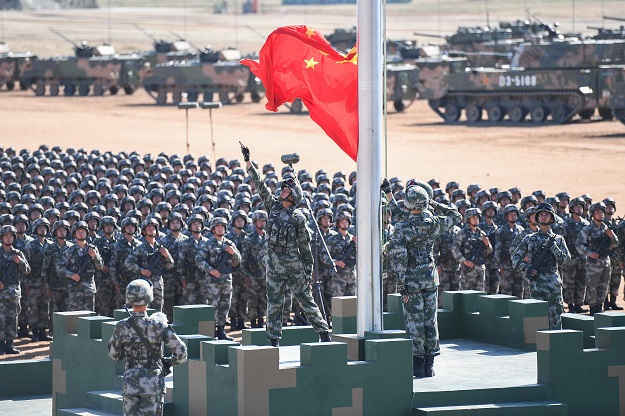 The Chinese flag is raised during a military parade at the Zhurihe training base in China's northern Inner Mongolia region. PHOTO: AFP