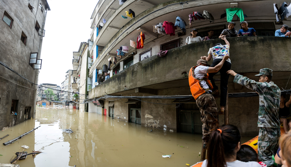 Rescuers transfer residents with a boat at a flooded area in Guilin, Guangxi province, China. PHOTO: REUTERS