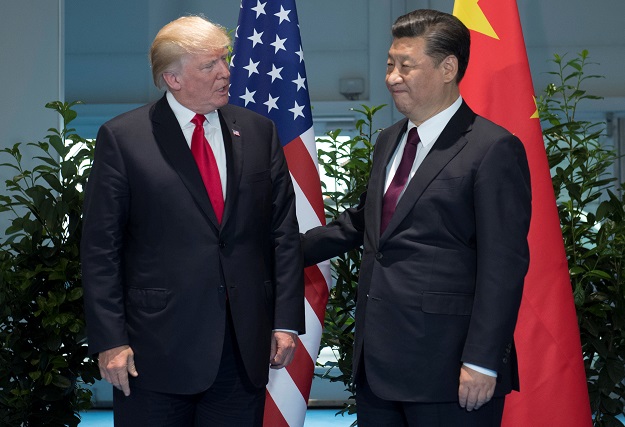  U.S. President Donald Trump and Chinese President Xi Jinping (R) meet on the sidelines of the G20 Summit in Hamburg, Germany. PHOTO: REUTERS