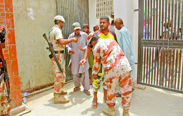All voters were searched twice before being allowed to enter the polling station. PHOTO: ATHAR KHAN/EXPRESS