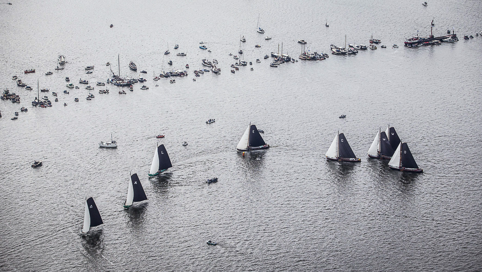 An aerial view shows sailing yachts taking part in the Skutsjesilen competition, a traditional boat race of boats from several Frisian cities, near Sneekermeer, The Netherlands. PHOTO: AFP