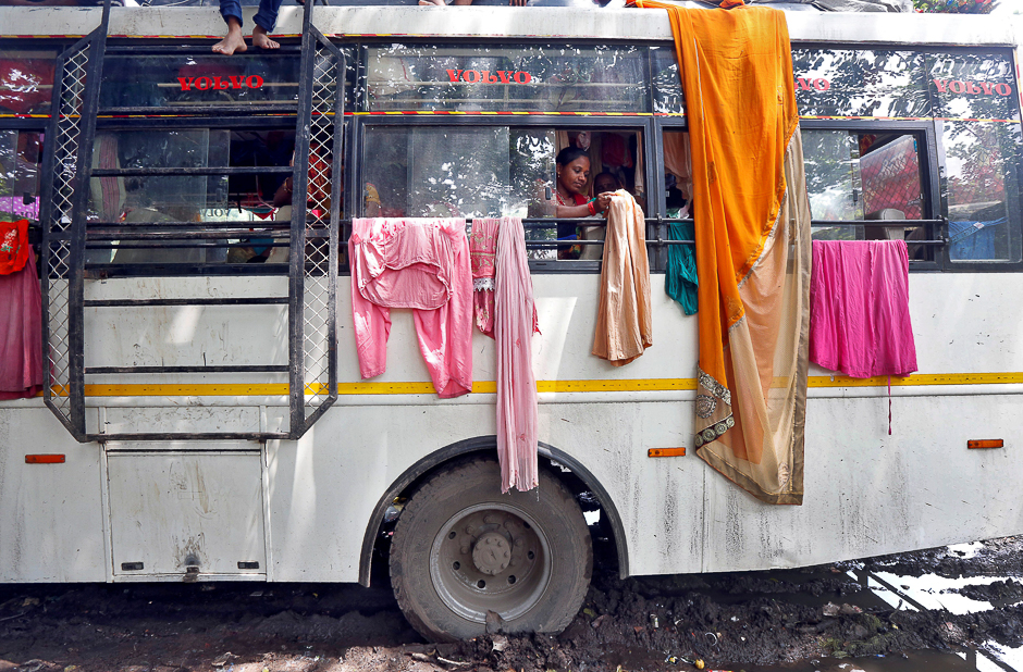 A Hindu pilgrim hangs clothes on iron rods tied to windows of a parked bus to dry on the banks of the river Ganges in Kolkata, India. PHOTO: REUTERS